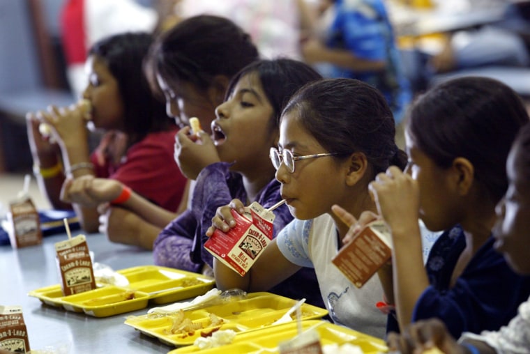 Children of migrant workers, most of whom work in the seasonal blueberry industry, have a healthy lunch at an elementary school in Sicklerville, N.J., June 29, 2005. The children, whether toddlers or teens, automatically qualify for a free, state-of-the-art summer school, with a multilingual staff committed to teaching and encouraging pupils they might never see again after the berry season ends. (AP photo/Mel Evans)