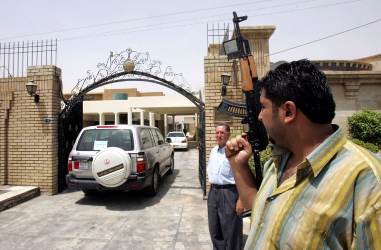 A vehicle carryies unidentified officials out of the Algerian embassy as they leave the Iraqi capital of Baghdad on Monday, July 25, 2005.  Two people have been detained in connection with the kidnapping of two Algerian diplomats last week, an Iraqi Interior Ministry official said Monday. (AP Photo/str)