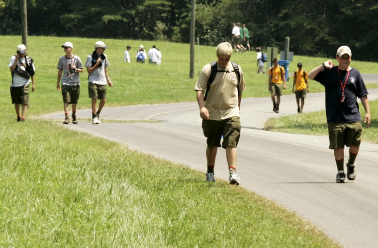 A group of Boy Scouts walk back to their base camp at Fort A.P. Hill in Bowling Green, Va., on Tuesday, a day after the deaths of four Boy Scout leaders at the National Jamboree being held there.
