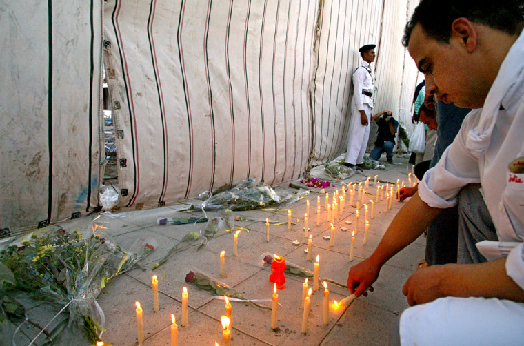 Egyptians light candles and lay flowers