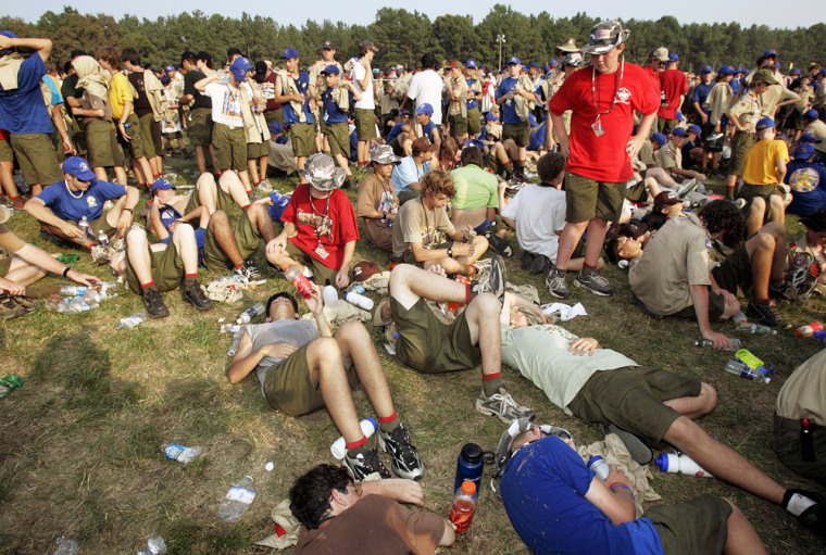 Boy Scouts are seen sitting and lying down as temperatures reach the upper 90s, on Wednesday, during the National Boy Scout Jamboree at Fort AP Hill in Bowling Green, Va. 