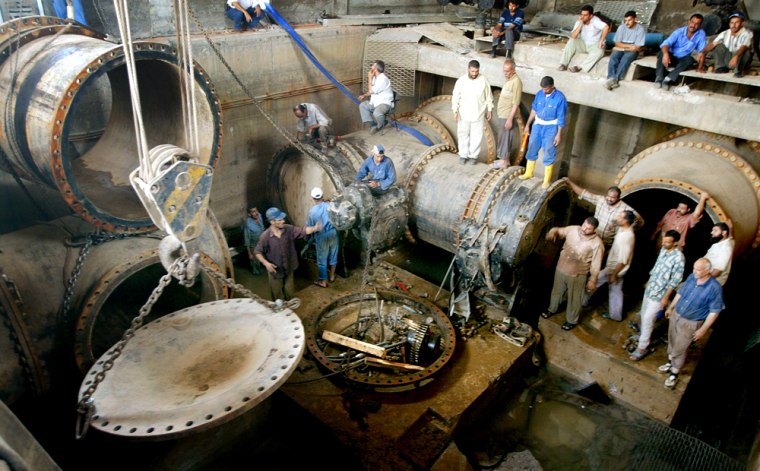 Iraqis work at rebuilding war damaged water works in Baghdad