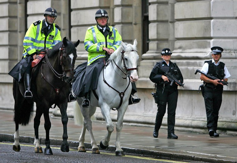 Mounted and armed police officers patrol in London