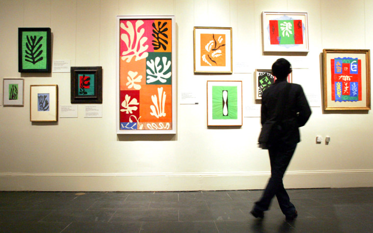 A visitor at the Metropolitan Museum of Art Monday, June 20, 2005, looks at a group of paper cutouts painted with gouache by artist Henri Matisse on display in the exhibit "Matisse: The Fabric of Dreams - His Art and His Textiles" in New York. 