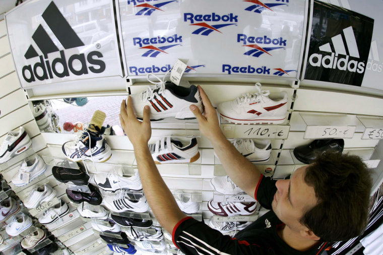 Hosemann arranges sports shoes in his store in the northern German town of Hamburg
