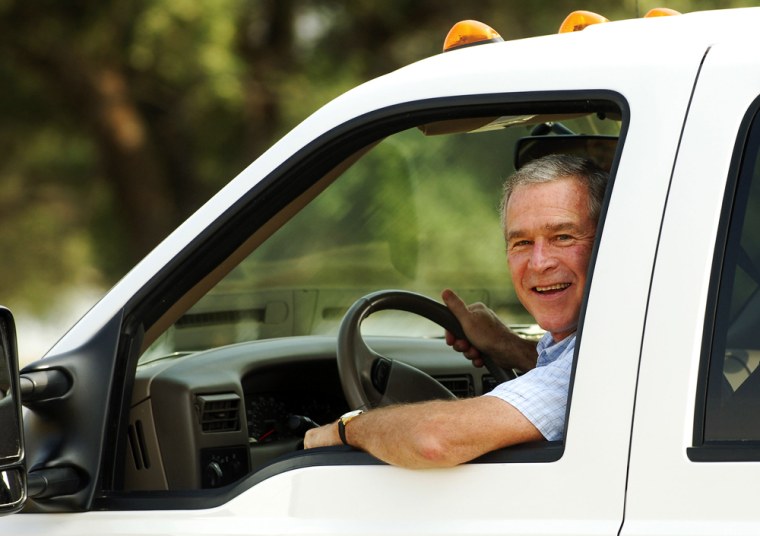 US President George W. Bush drives in hi
