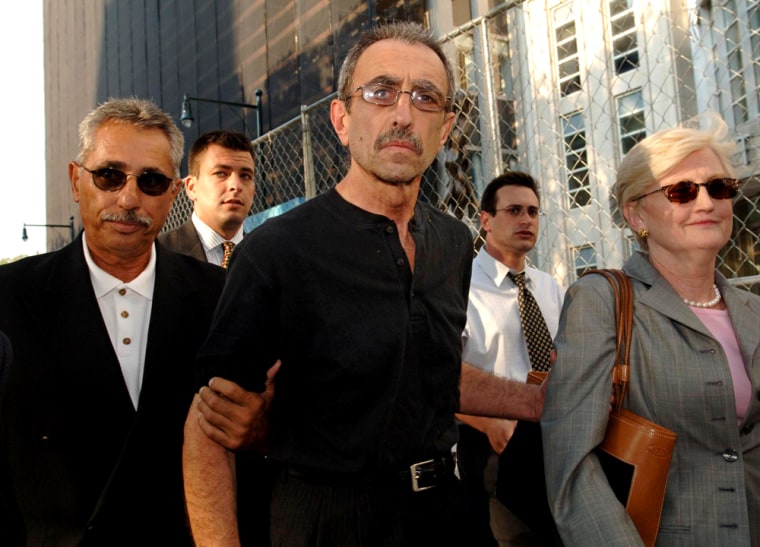 Former New York City police detective Stephen Caracappa exits Federal Court escorted by his brother Domenic, left, and  attorney Rae Koshetz, right, Thursday, July 21, 2005, in the Brooklyn borough of New York. Caracappa, 63, and former partner and detective Louis Eppolito, 56, were each released on a $5 million bond. The former partners stand accused of leading double lives at hitmen for the mob, gunning down, kidnapping and tracking down rivals of a Lucchese family underboss for tens of thousands of dollars in blood money. (AP Photo/ Louis Lanzano)