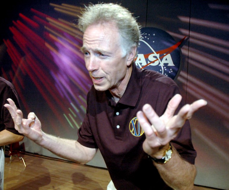 Greg Olsen gestures during briefing at Johnson Space Center in Houston
