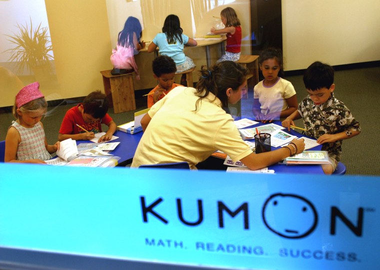A volunteer helps Kumon students with their assignments at the Kumon of Capital Hill at Eastlake in Seattle.