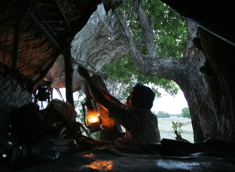 Sri Lankan villager prepares to spend night on tree house in Galgamuwa, Sri Lanka