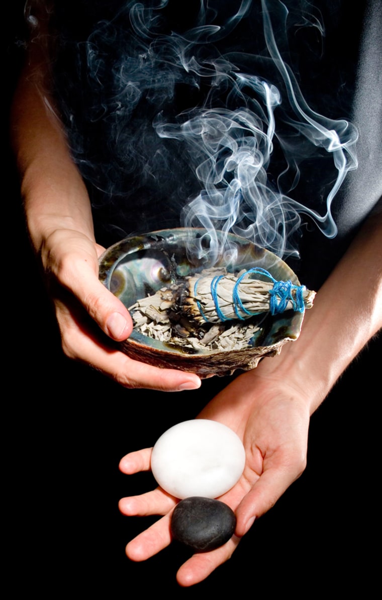 Dried herbs are burned as part of a smudging ceremony, and stones are applied to the body for therapeutic treatment, shown in this Aug. 6, 2005, at the Miraval Life in Balance Spa in Catalina, Ariz.