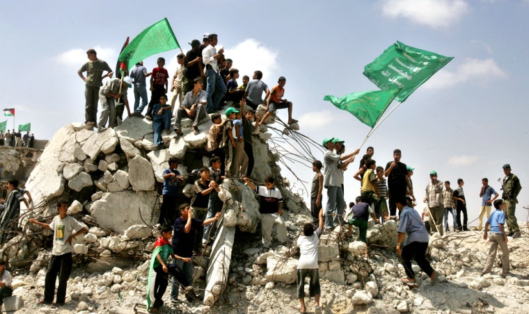 Palestinians wave Hamas flags during rally in early celebrations for Israel's imminent pullout in Gaza Strip