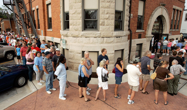 Residents of Stoughton, Wis., wait in line outside City Hall Friday, Aug. 19, 2005, for arm bands so they can return to their homes after a tornado ripped through Stoughton Thursday evening.  The city still reeling from a major church fire now must deal with the devastation of a tornado that killed one person and destroyed or damaged dozens of homes.  (AP Photo/Andy Manis)