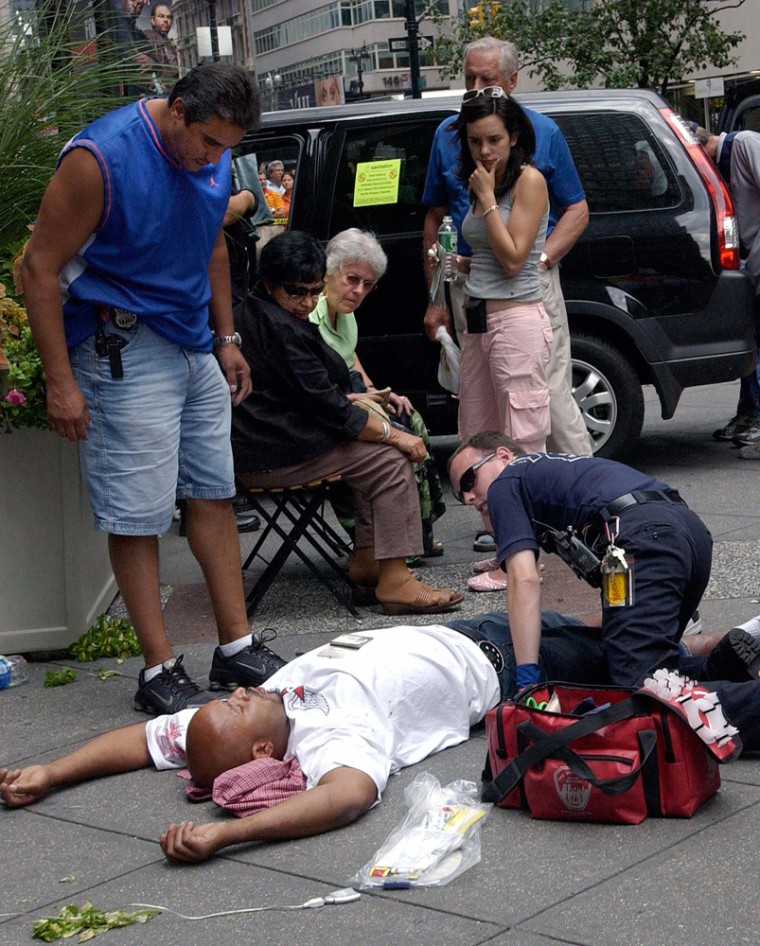 An injured man is attended to at the scene of motor vehicle accident injuring pedestrians in New York