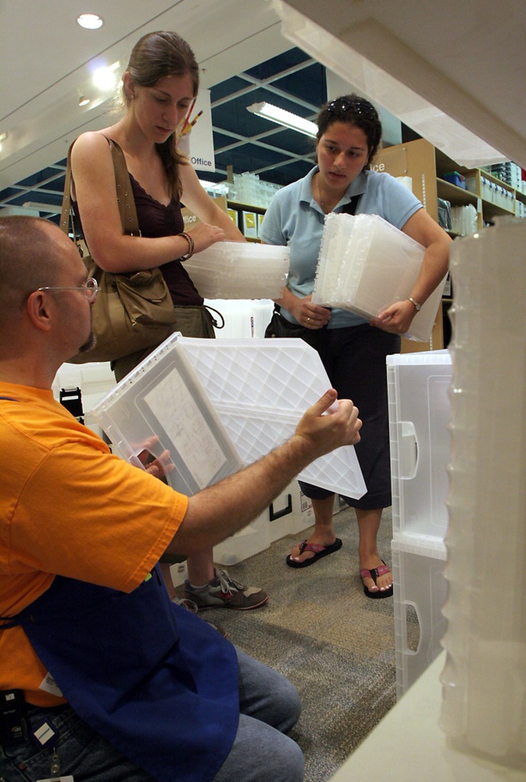 Container store 'college expert' David Hobrock, left, demonstrates a stacking container system for Celeste Tinari and Nicole Tingir, both 20-year-old juniors at Georgetown University, who are shopping for book storage.