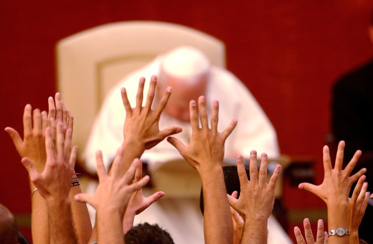Faithful raise their hands in front of Pope John Paul II in Castelgandolfo, Italy, in this 2003 photo. John Paul II's secretary recently said the pope heard his follower's prayers as he lay on his deathbed.