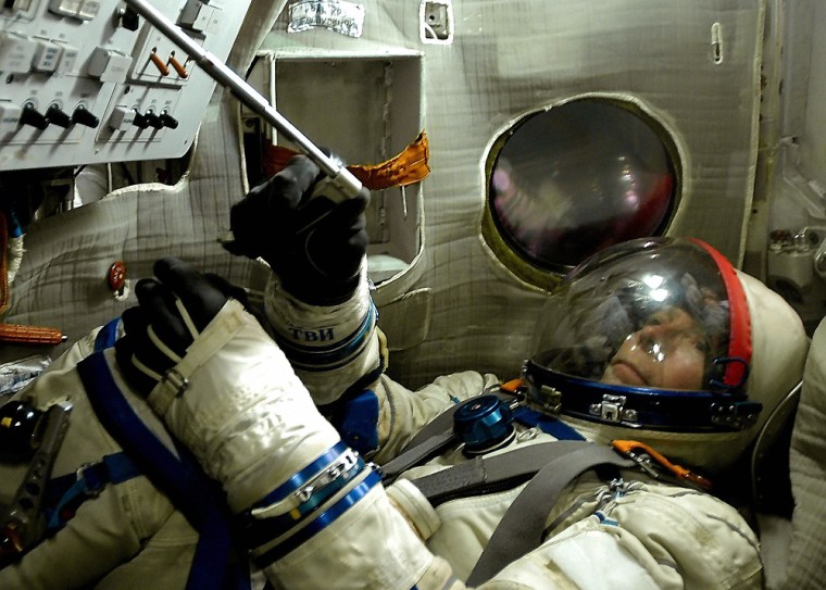US space tourist Gregory Olsen practises in a Soyuz training module in Star City near Moscow
