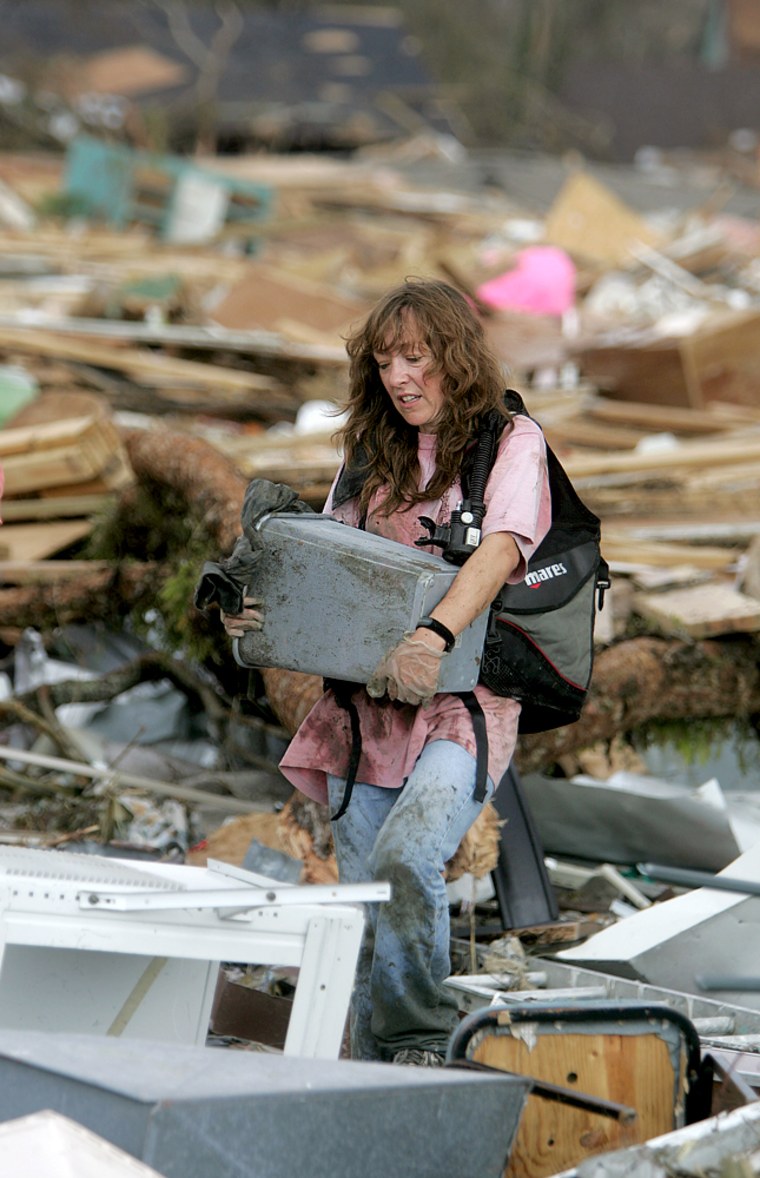 Alison Dean carries what she can from her home in Waveland, Miss. on Wednesday, after it was destroyed by Hurricane Katrina.