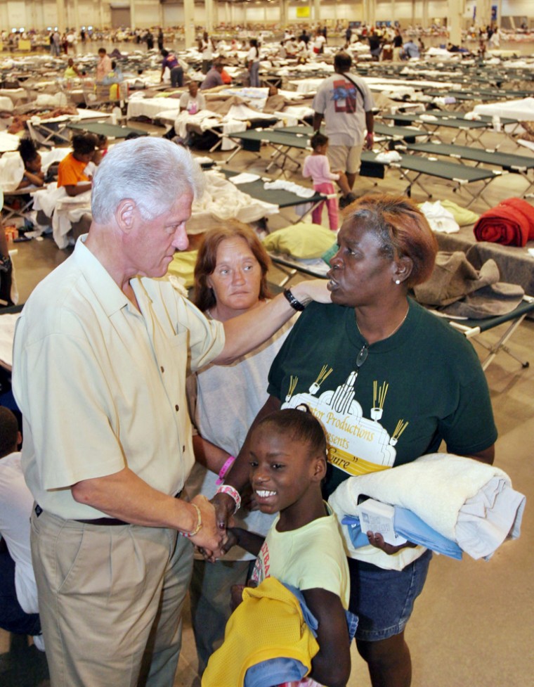 Former US president Bill Clinton visits with Hurricane Katrina evacuees in Houston, Texas