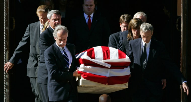 The casket of Supreme Court Chief Justice Rehnquist is carried from the cathedral in Washington