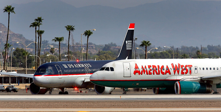 America West and US Airways jets taxi at Sky Harbor International Airport in Phoenix in this Sept. 4 photo. Officials say the two companies could start operating as one by the beginning of October.