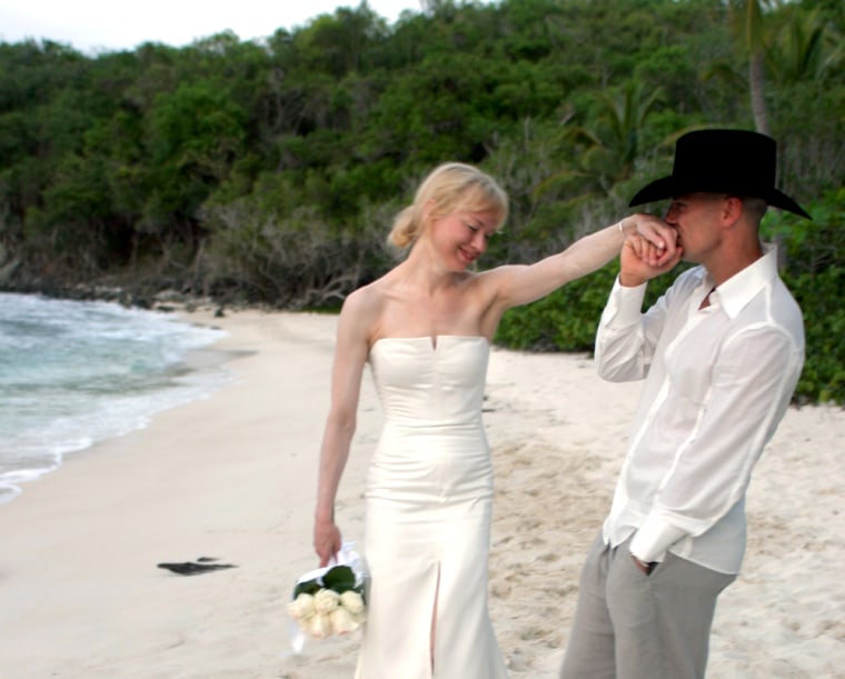 This photo from Carolina Herrera shows country music star Kenny Chesney kissing the hand of his bride, actress Renee Zellweger, wearing her Carolina Herrera designed wedding dress, on the beach in Cruz Bay, on St.John  in the U.S. Virgin Islands on Monday, May 9, 2005. (AP Photo/Carolina Herrera)