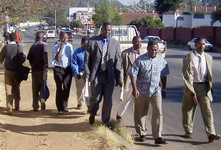 Opposition Movement For Democratic Change leader, Morgan Tsvangirai, second from right, makes a 75 minute walk to work in Harare, on Friday to protest fuel shortages that have crippled Zimbabwe's transport system. 