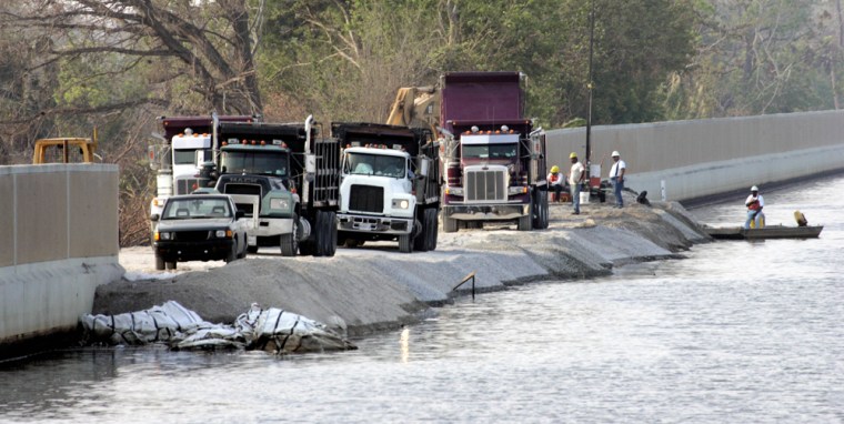 Work continues on a breach in a levee along the 17th Street Canal in New Orleans, La., on Tuesday.