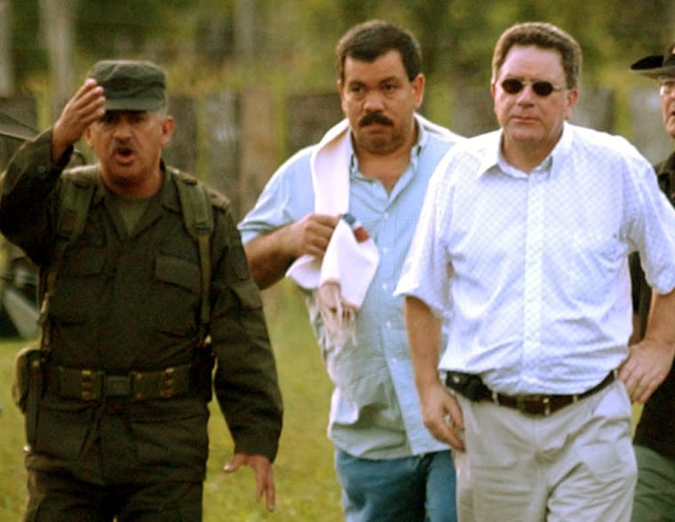 Diego Fernando Murillo, center, surrenders in Santa Fe de Ralito, Colombia, on May 27, 2005.