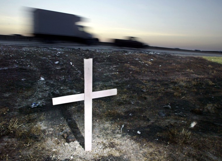 A single cross marks the scene of a bus that caught fire and burned on Interstate 45, killing 23 people, Sept. 23 in Wilmer, Texas. The bus was carrying elderly Hurricane Rita evacuees from the Houston area.