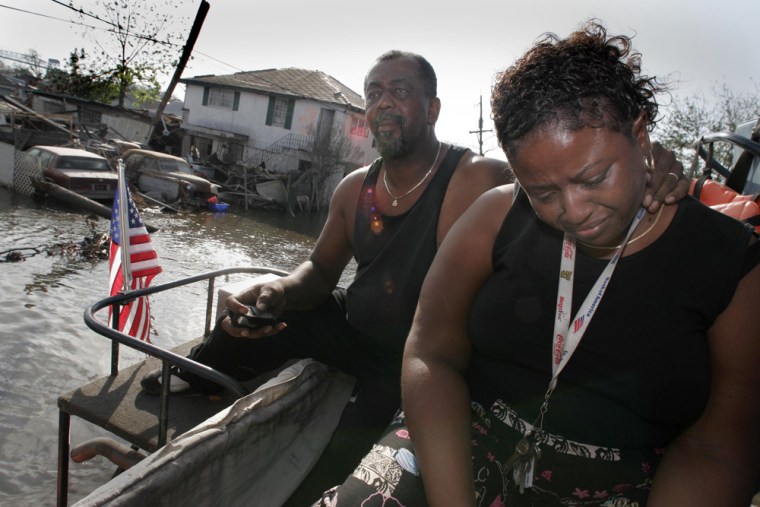 Jacqueline Robinson is comforted by her husband Steven after she saw her street in the New Orleans' Lower 9th Ward under water. 