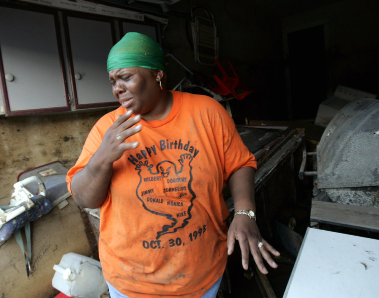 Tamyra Bacchus winces after opening a freezer in her home in the Ninth Ward of New Orleans on Saturday. 