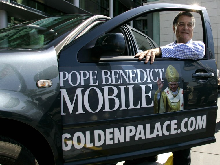 GoldenPalace.com CEO Richard Rowe poses with the second-hand car, once registered in the name of German Cardinal Joseph Ratzinger, the new Pope Benedict XVI, during a presentation in Cologne