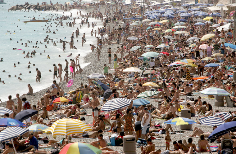 People sunbathe on the beach in Nice, southern France, during the peak of the summer holiday season earlier this year. Europeans' habit of taking the entire month of August off is making the continent less competitive, an EU official said.