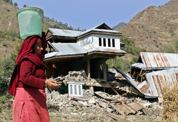Kashmiri quake survivor carries water in Karnah