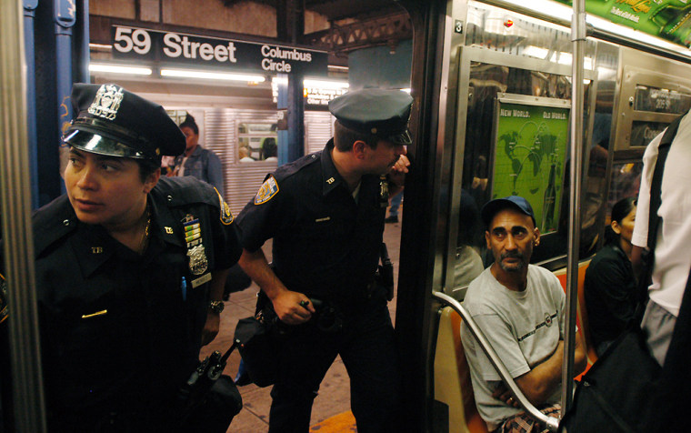 New York City police check subway cars on Oct. 7 after a specific terrorist threat to the subway system, which proved to be false, was announced.
