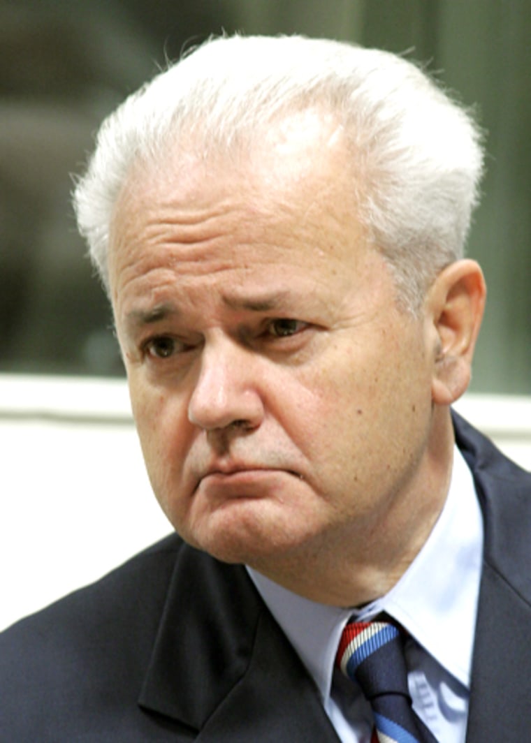 Former Yugoslav President Slobodan Milosevic enters a court room of the war crimes tribunal in The Hague, Netherlands, Tuesday Aug. 31, 2004. Milosevic opened his defense case at the Yugoslav war crimes tribunal Tuesday, starting the long-delayed second half of his trial on charges of genocide and other war crimes in the Balkans. (AP Photo/Fred Ernst, Pool)