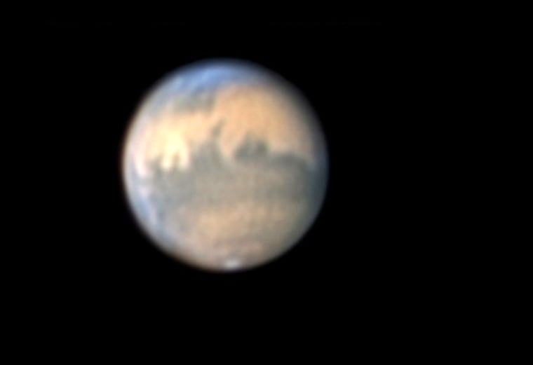 Sky & Telescope's Sean Walker used a Webcam on a 7-inch telescope to capture this view of Mars on Oct. 17–18. Note the dark markings across the disk, the tiny south polar cap at the bottom, and the bluish north polar hood of clouds at the top.