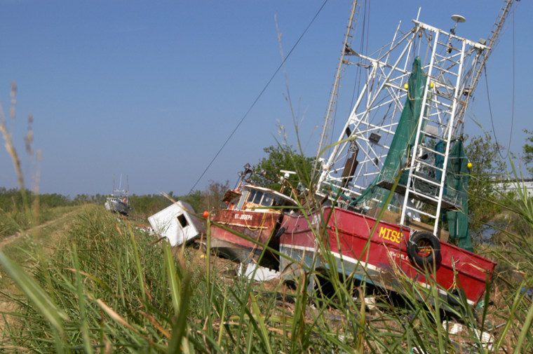 Fishing boats lie washed up against a levee last month in the Bayou Sauvage National Wildlife Refuge.