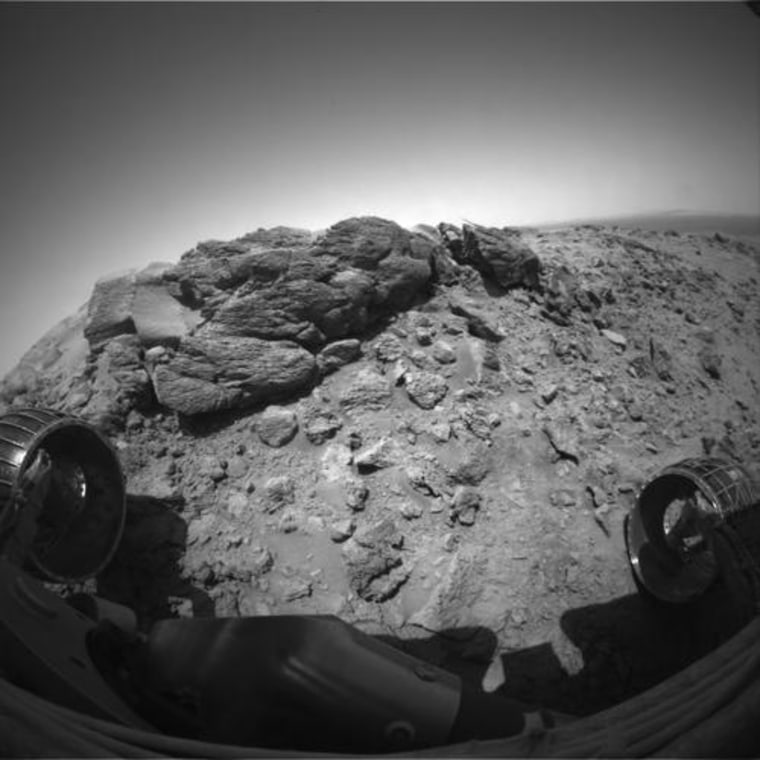 NASA's Mars Exploration Rover Spirit completed a difficult, rocky ascent en route to reaching a captivating rock outcrop nicknamed 'Hillary' at the summit of 'Husband Hill.' At the end of the climb the robotic geologist was tilted almost 30 degrees and had to wiggle its wheels to gain a more solid footing.