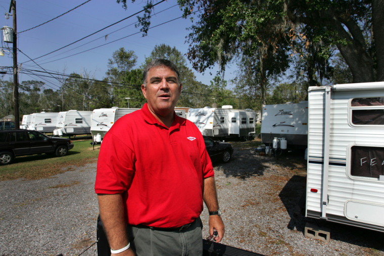 Marty D. Owens, Investment Recovery Operations Specialist for Dow stands surrounded with trailers used for living quarters for the Dow employees, in Pardis, La. Thursday, Oct. 13, 2005. Dow assigned  Owens _ whose usual job is auctioning off the plant's surplus materials _ to find a place for 150 trailers.  (AP Photo/Judi Bottoni)