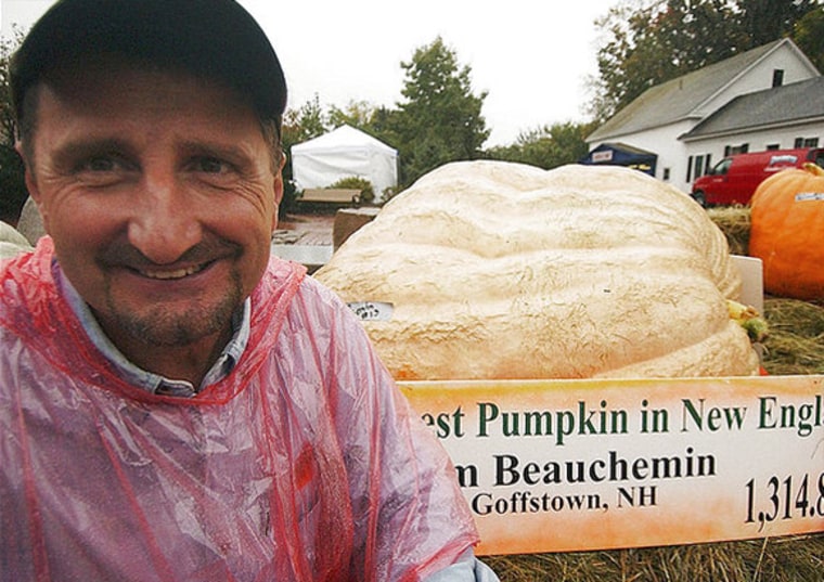 Jim Beauchemin of New Hampshire shows off his prize-winning pumpkin -- all 1,314.8 pounds of it. At times this summer, the pumpkin grew 35 pounds a day.