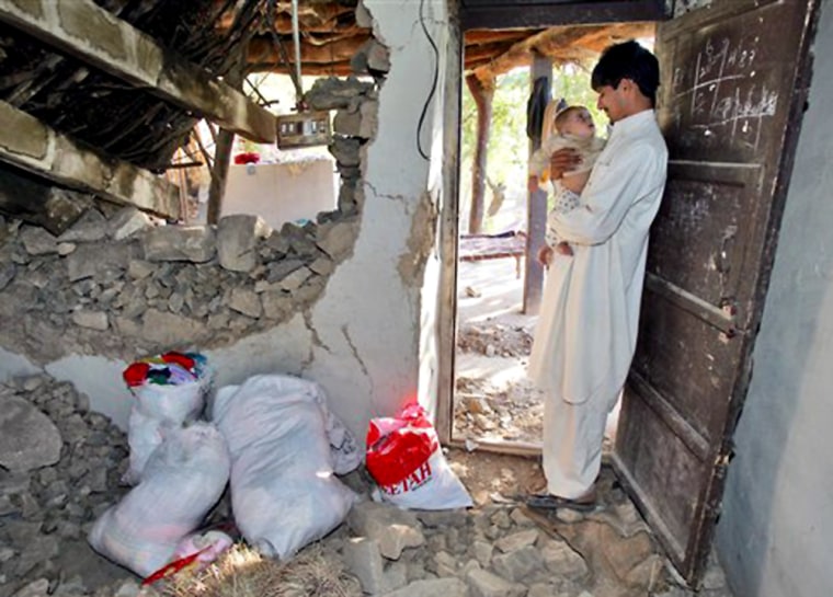 Usman Abbasi spends a quiet moment with his daughter Iman at their earthquake destroyed home in the rural Kashmir mountain village of Munnasa, Pakistan. While no one in the Abbasi family was killed, 22 girls were lost in a nearby school and more than 250 homes in the community were destroyed.