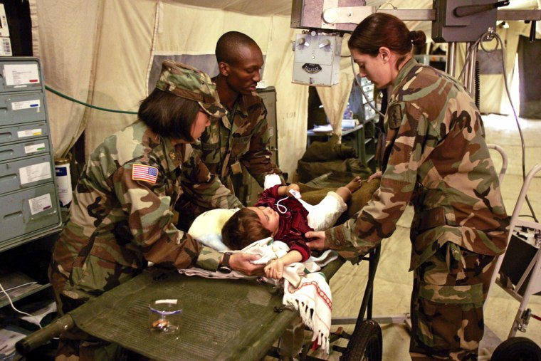 Medical personnel from US MASH treat Kashmiri earthquake victim at field hospital in Muzaffarbad