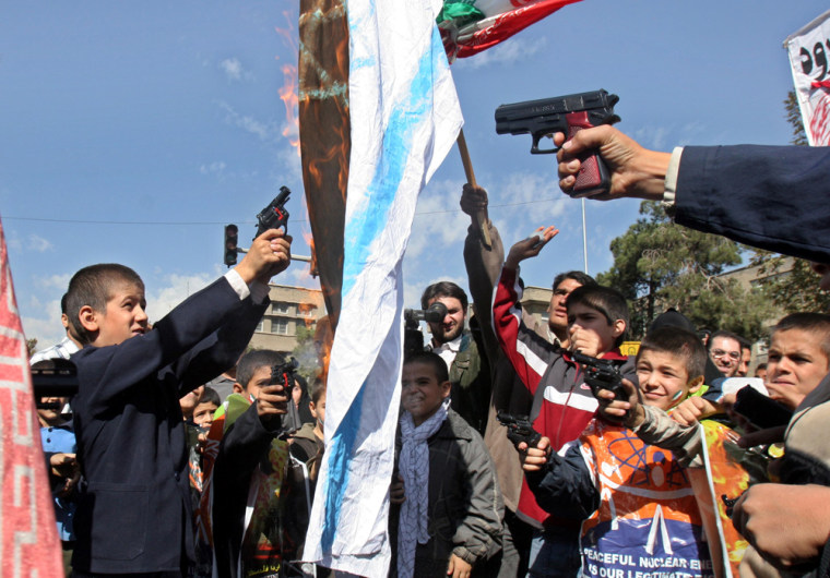 Iranian school boys shoot with their toy guns at an Israeli flag as it burns during an anti-Israeli rally marking \"Al-Quds Day\" (Jerusalem Day), to support the Palestinian cause, in Tehran, Iran, Friday, Oct. 28, 2005. Tens of thousands of Iranians staged anti-Israel protests across the country Friday and repeated calls by their ultraconservative president who repeated the words of the late Ayatollah Ruhollah Khomeini, founder of Iran's Islamic revolution, by saying: \"Israel must be wiped off the map.\"  (AP Photo/Vahid Salemi)