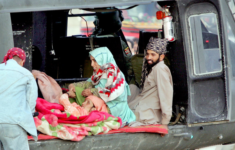 Injured earthquake survivors lie in a helicopter as they leave for Islamabad in Balakot