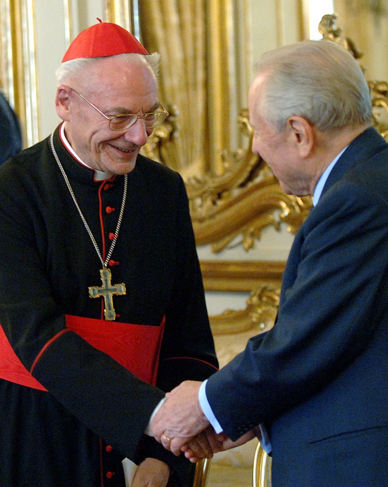 French Cardinal Paul Poupard, seen in this June photo shaking hands with Italian President Carlo Azeglio Ciampi, says the Vatican wants to help end the "mutual prejudice" between religion and science.