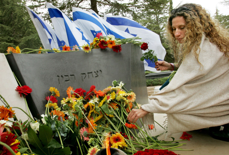 An Israeli woman lays a flower at the grave of late Israeli Prime Minister Yitzhak Rabin during a memorial at Mount Hertzl cemetery in Jerusalem on Friday.