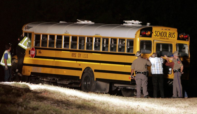 A Royse City school bus is shown after it was pulled upright in rural Collin County, Texas, on Thursday night.