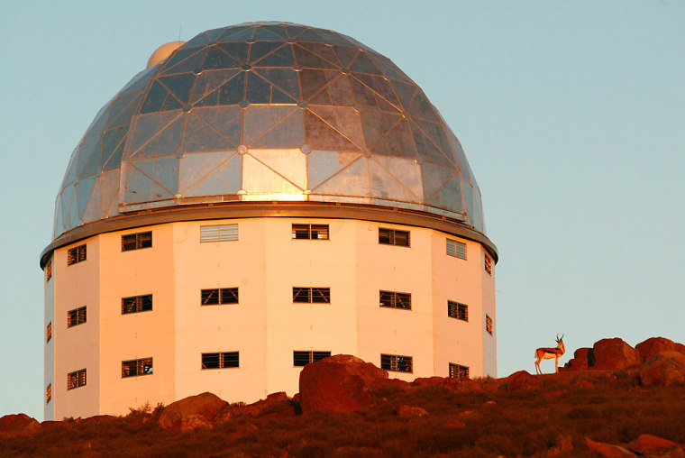 File photo of a lone springbok standing beside the building housing the Southern African Large Telescope on a hilltop near Sutherland